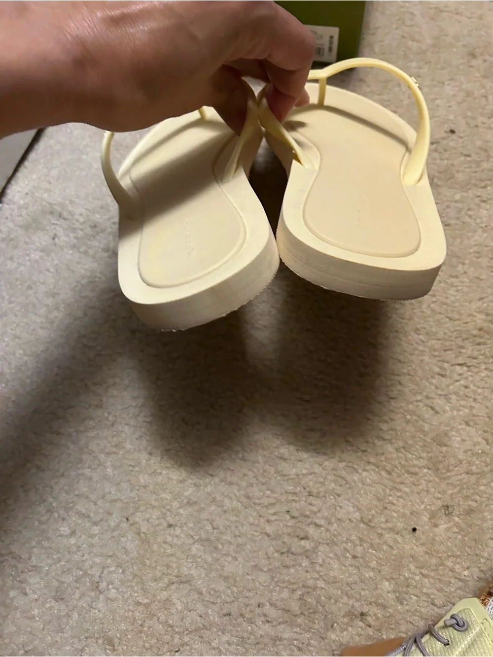 TORY BURCH KIRA padded flip flops in light yellow.